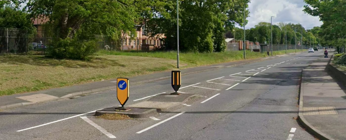 A refuge island with keep-left bollards in the middle of a road